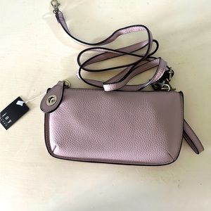 Brand new, never used wristlet that can turn into a crossbody, light plum color